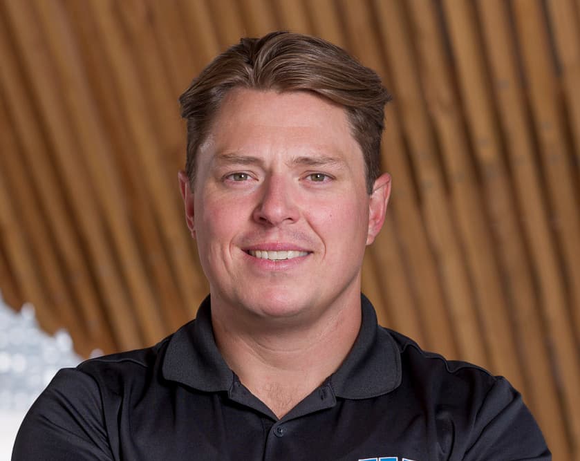 A man with short brown hair in a black shirt